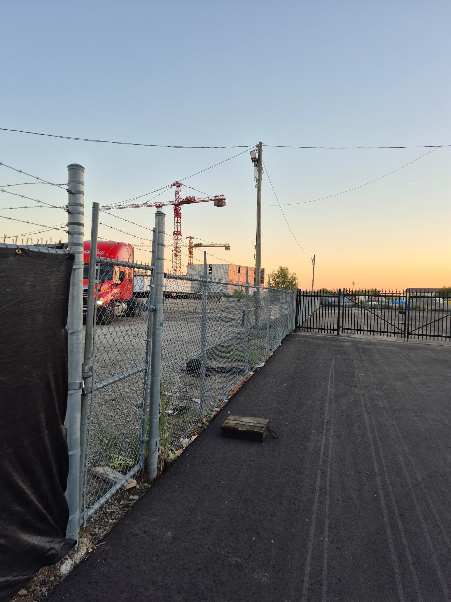 Commercial chain-link security fence with gate