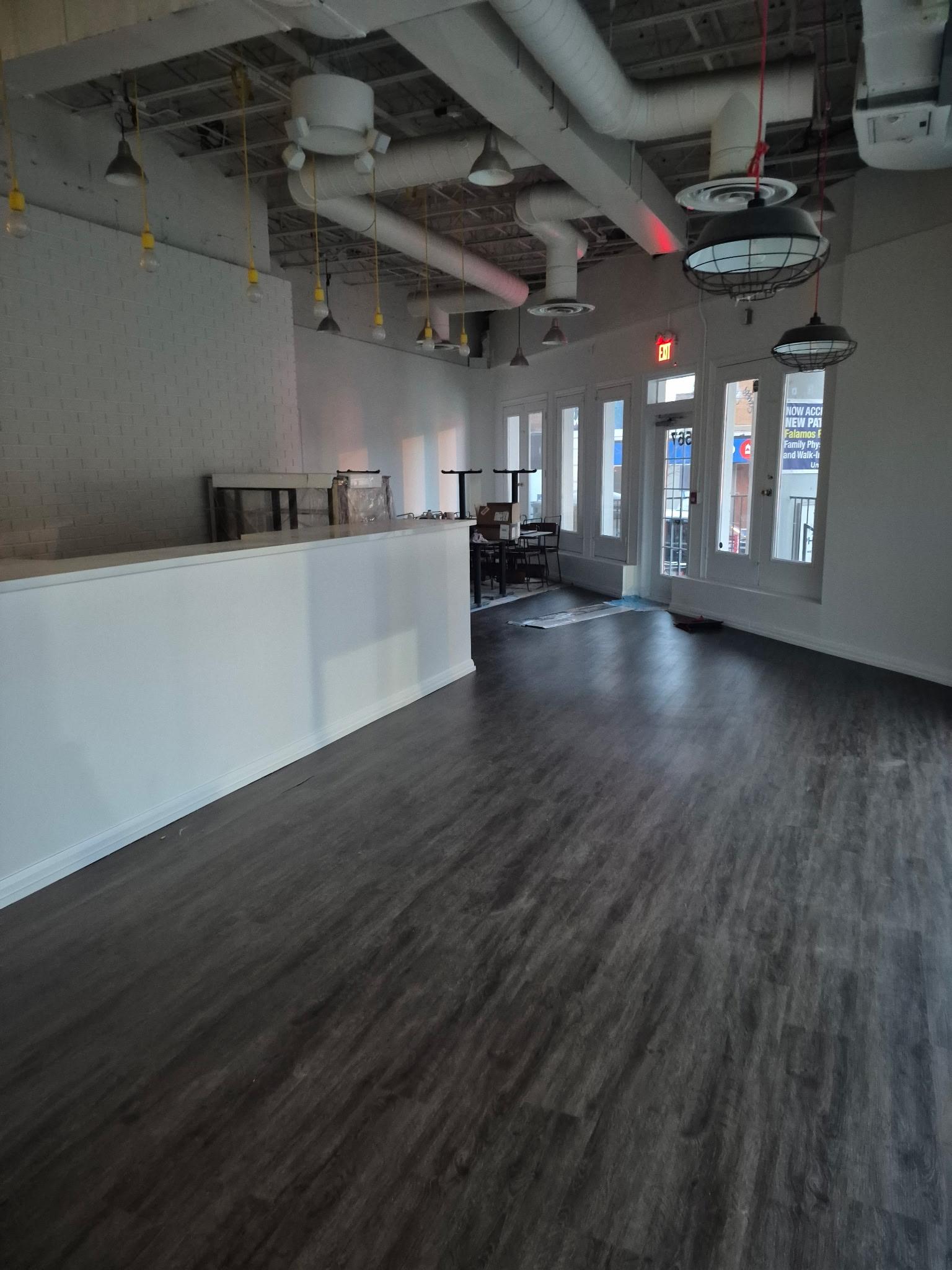 Commercial retail space renovation with new flooring and counter