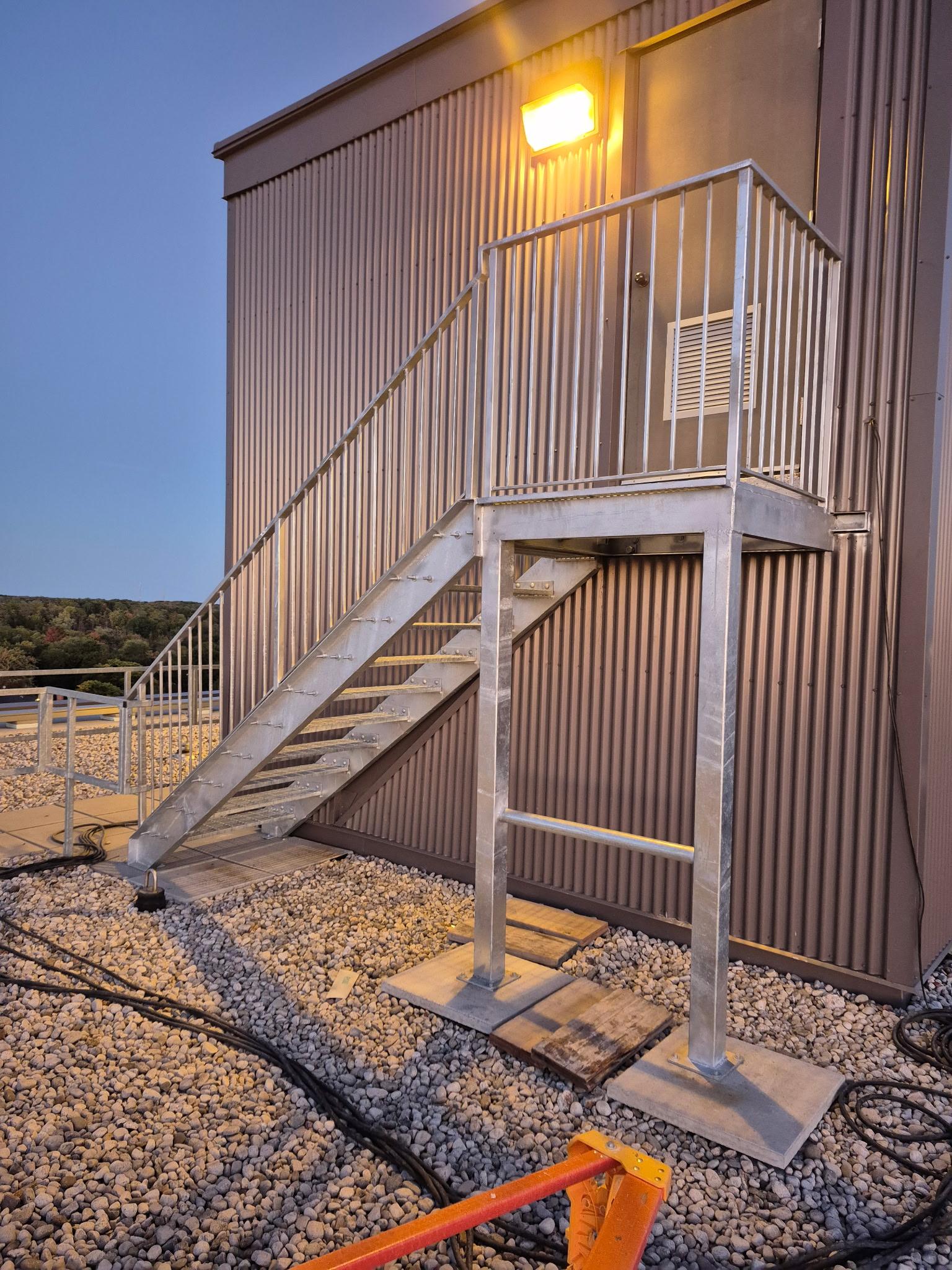 Galvanized steel rooftop access staircase and platform