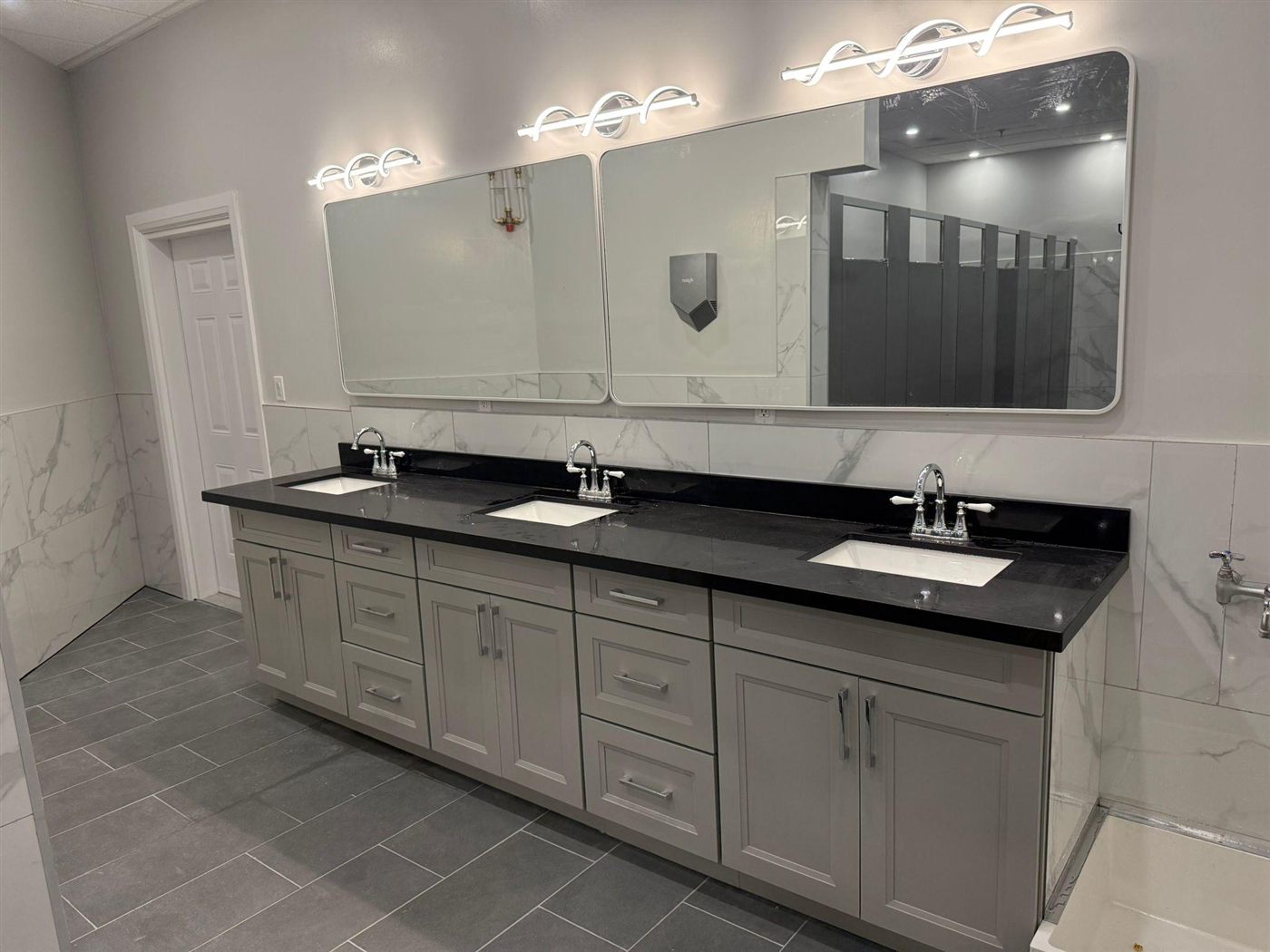 Triple-sink bathroom vanity remodel with black granite